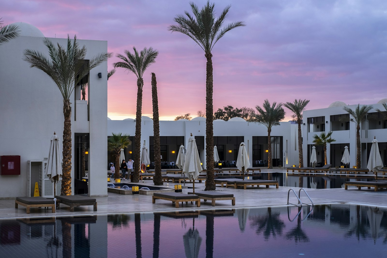 Poolside boutique hospitality property at sunset