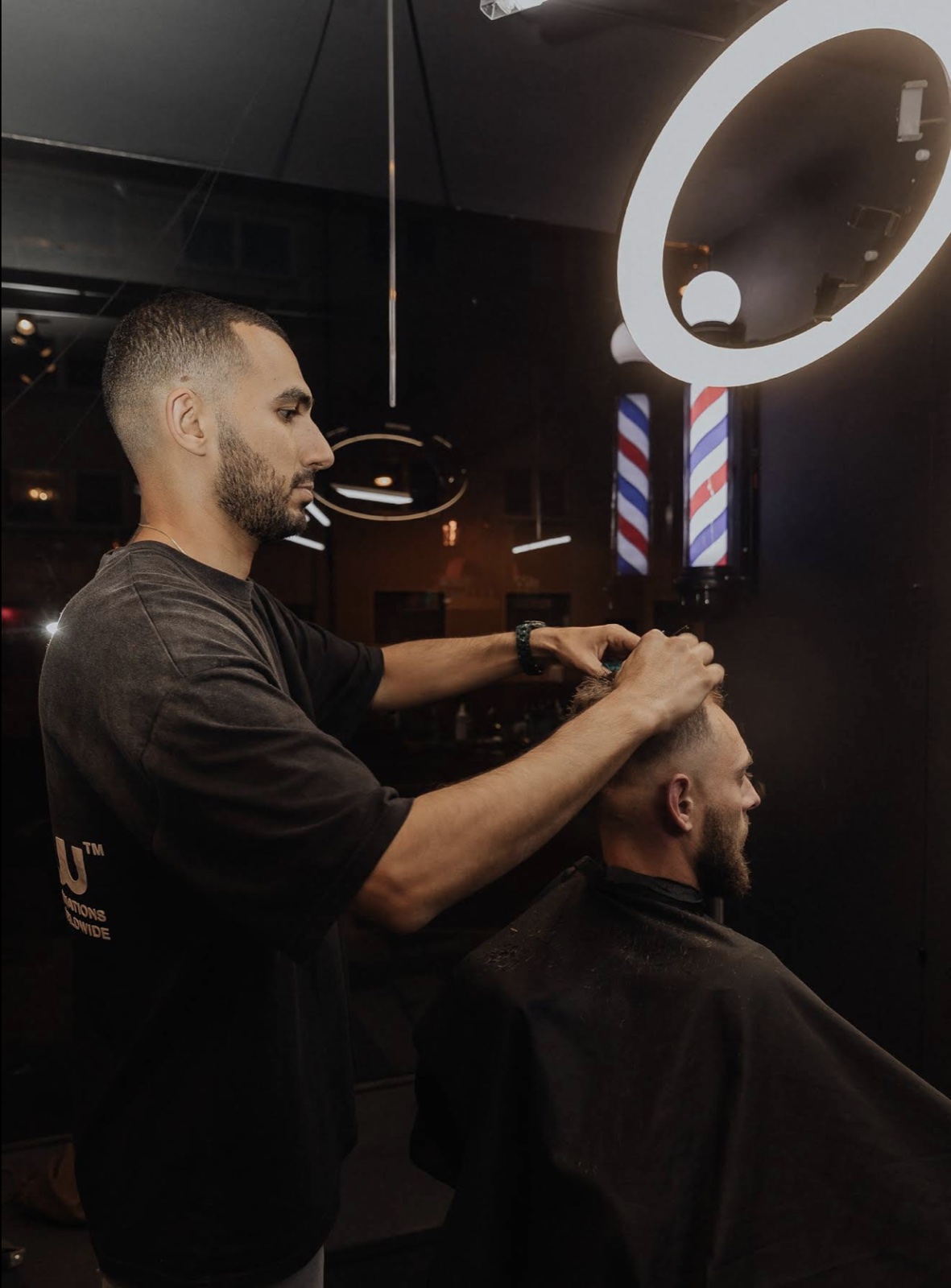 Barber working with a client at MK Studio
